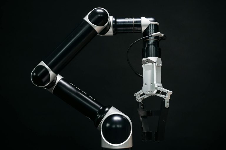Close-up of a mechanical robotic arm with a dark background, showcasing advanced technology.