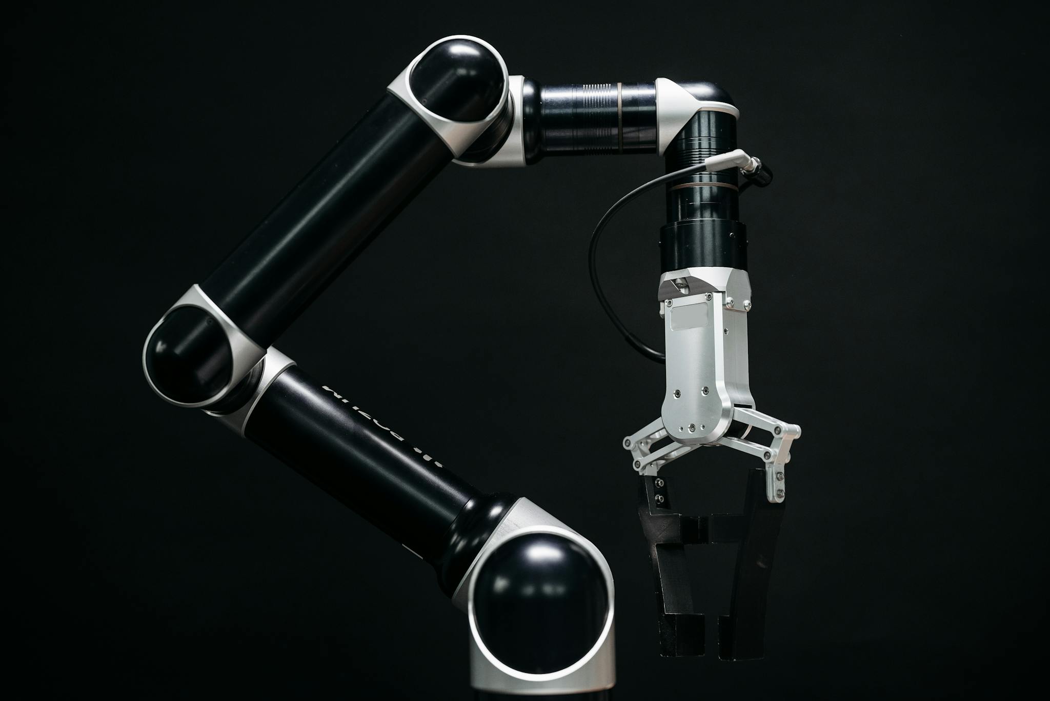 Close-up of a mechanical robotic arm with a dark background, showcasing advanced technology.