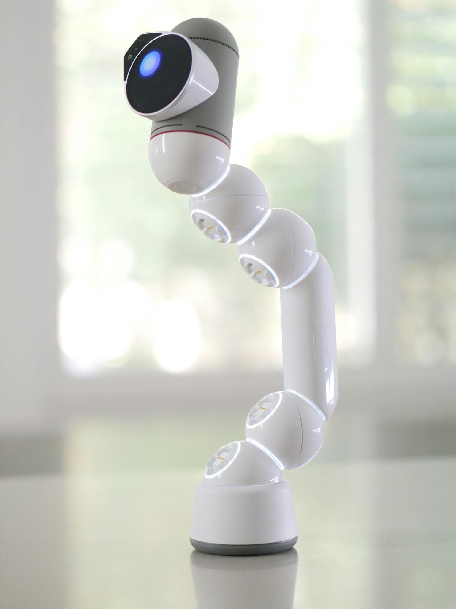 Futuristic robotic arm with camera lens for innovative technology applications.